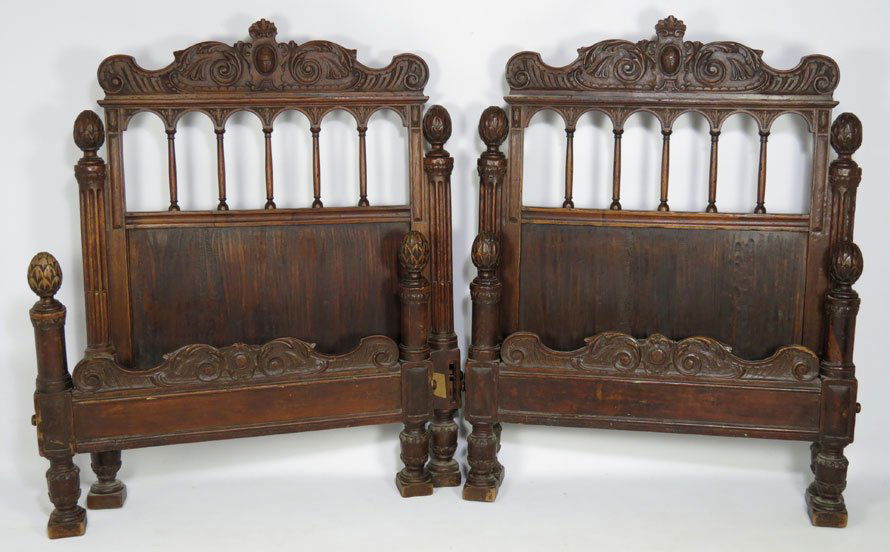 PAIR OF ITALIAN BAROQUE CARVED WALNUT BEDS: single-size, carved shield crest headboard, with artichoke carved post tops, rails included, 51"h; 39"w