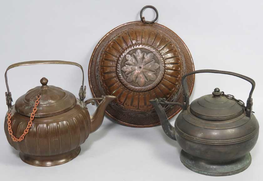 (3) RENAISSANCE METAL ITEMS: a copper mold, embossed with birds, dolphin and scrolling foliage, ring for hanging, 5"h; 11"diam.; along with two bronze kettles with swing handles, 6"h