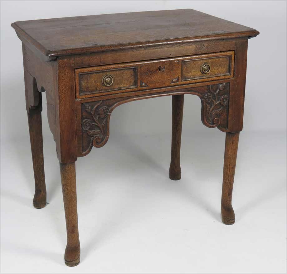 ENGLISH GEORGE III OAK ARCHITECTS DESK: lid lifts with rachet support, scrolled apron with floral carving, 29”h; 25.5”w; 18”d