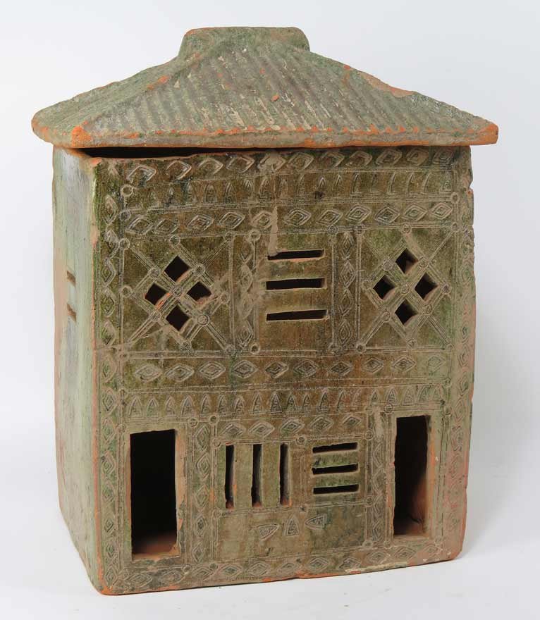 GLAZED EARTHENWARE HOUSE MODEL: Eastern Han, the front with cut-out windows and door and incised decoration, green glaze, the sides and back with less glaze, removable tile roof, 14”h; 10.5”w; 8”d Prov.: The David Abbate (1949