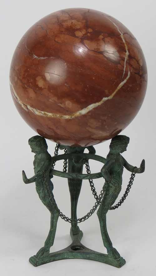 STONE ORB ON POMPEII-STYLE METAL BASE: brown marble, 5.5”diam., on 3-figure verdigris base, 10.5” total h Ex. Kurt Reynolds collection, Boston