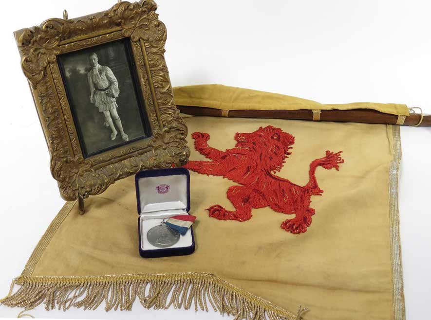 (3) EDWARD VIII ITEMS: a photograph of Edward as a teenager in costume, nouveau brass frame; a 1937 commemorative coronation medal in box; and small needlework banner of depicting a rampant lion in red thread Ex. Kurt Reyno