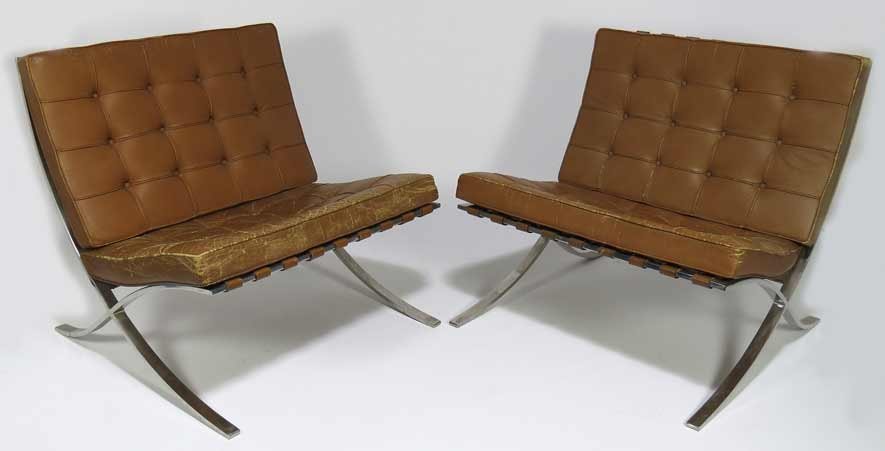 PAIR OF MID-CENTURY MODERN BARCELONA CHAIRS: designed by Miles van der Rohe, c. 1929 for Knoll, autumn tan leather, 29”h; 29”w Prov. Purchased in 1956 by the interior designer for the mid-cen. modern home, The Strauss House, in Pound Ridge, 