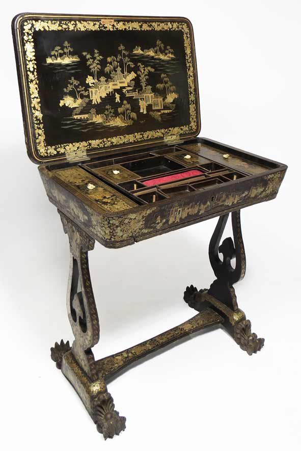 CHINESE EXPORT BLACK AND GOLD LACQUERED SEWING TABLE: mid 19th c., elaborate chinoiserie figures in a landscape with buildings to exterior and interior of the hinged lid, the interior fitted with open and lidded compartments, overall figural and floral c