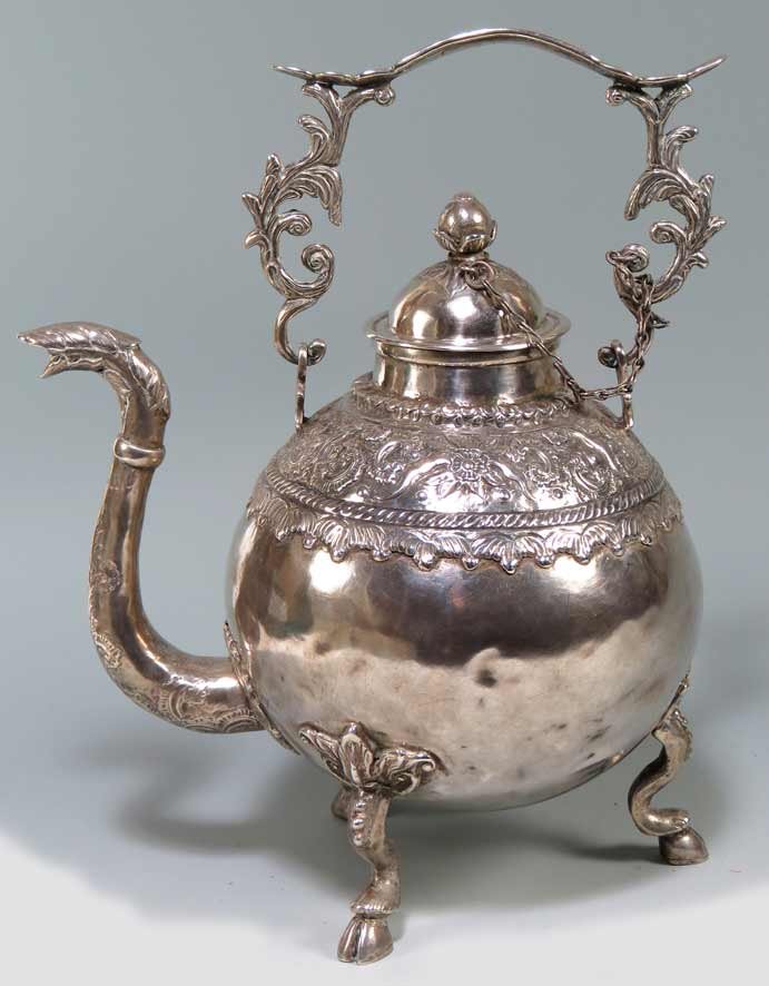 SPANISH COLONIAL SILVER WATER KETTLE (TETERA): Colombia, c. 1800, bulbous body with animal head spout, on high hoofed legs, 12.5”h inc. handle up; kettle 10”h; 48 troy oz. Ex the private collection of a Connecticut gentleman and his wife who r