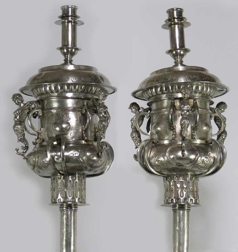 PAIR OF SPANISH COLONIAL SILVER PROCESSIONAL: Colombia, 18th c., the top portion a candle socket mounted on an ornate etched base with open rings and three winged females with fish lower body, 17”h, 9”w; mounted on 68” pole; overall 82.5”