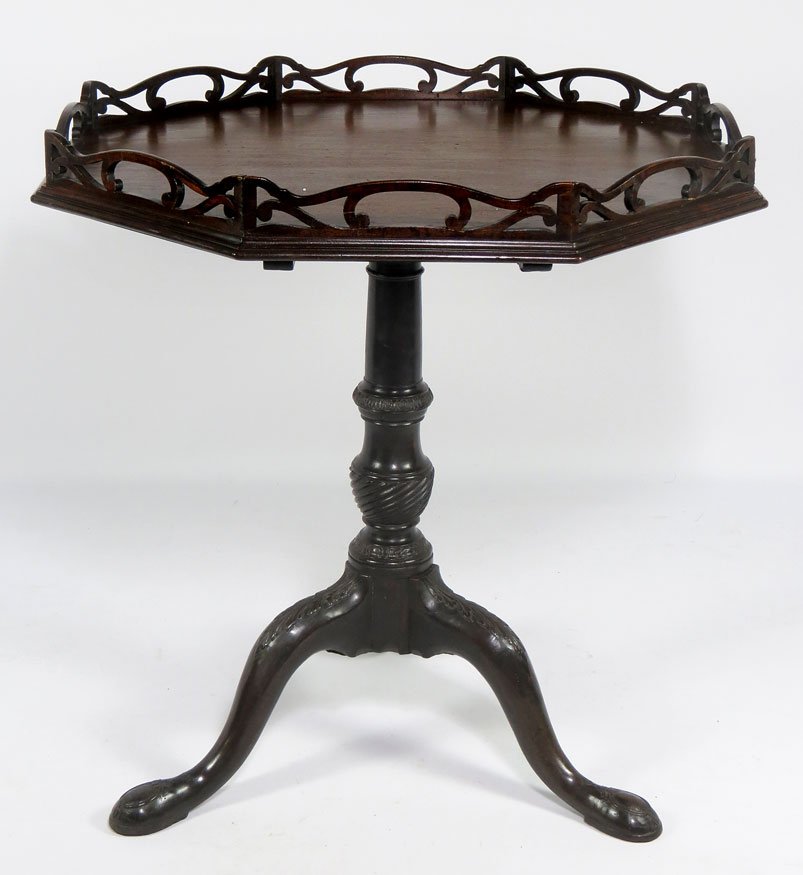 18TH C. IRISH WALNUT OCTAGONAL TEA TABLE: with pierced gallery, spiral post, carved knees and snake feet, 31”h; tilt top, 31”diam.
