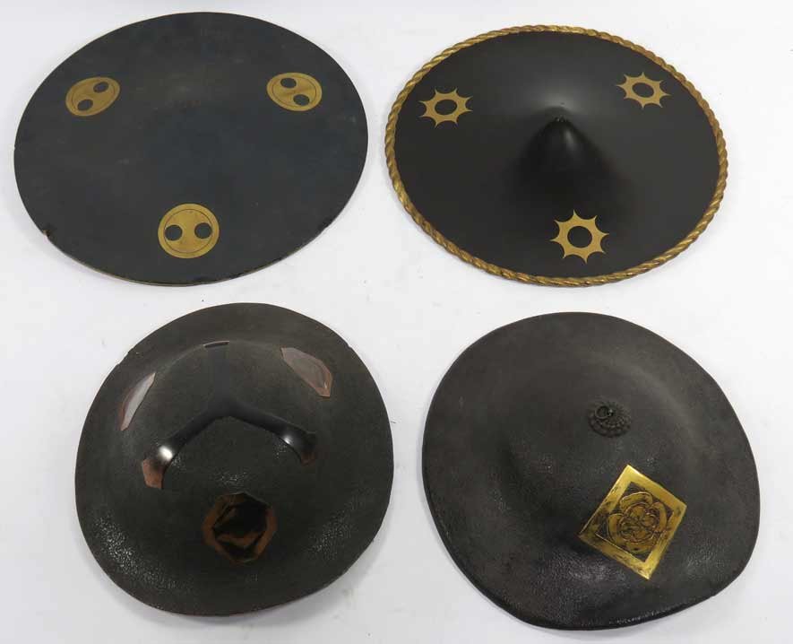 (4) VARIOUS JAPANESE SAMURAI HATS (JINGASA): all lacquer, (2) with rounded crowns; (2) of circular form, shallow points to center (one with edge chips) From the collection of the late David Abbate of New York and New Jersey.