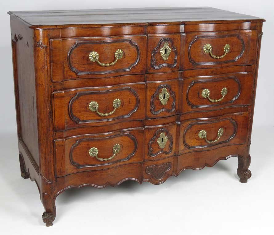 FRENCH PROVINCIAL SERPENTINE FRUITWOOD COMMODE: 18th c., serpentine-form, three drawers with old hardware and molded panels, paneled sides, carved shaped apron, scrolling foot, 36.5”h; 48”w; 23”d