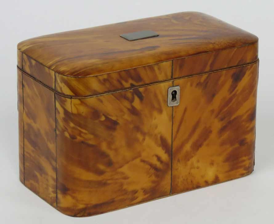 ENGLISH GEORGIAN TORTOISE SHELL TEA CADDY: rectangular-form with rounded edges, interior fitted with double tortoise-lidded compartments, silver lid mount and escutcheon, 4.5”h; 7”w; 4”d