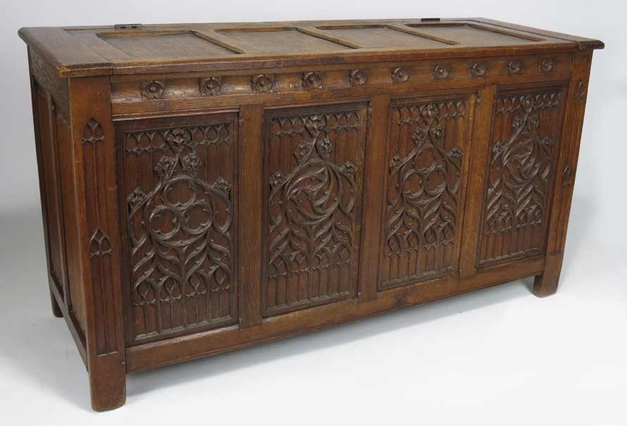 ENGLISH GOTHIC-REVIVAL OAK BLANKET CHEST: 19th c., hinged top, four architectural carved panels to front, 31”h; 57”w; 20.75”d