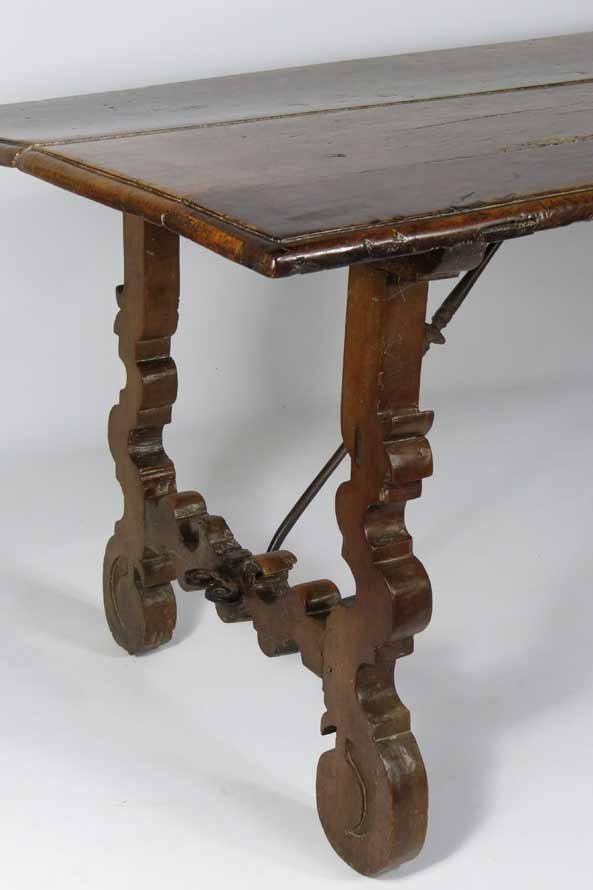 17/18TH C. SPANISH WALNUT TRESTLE TABLE: in old surface, scrolled trestles joined by wrought iron rods, 30”h; 83”w; 32.5”d