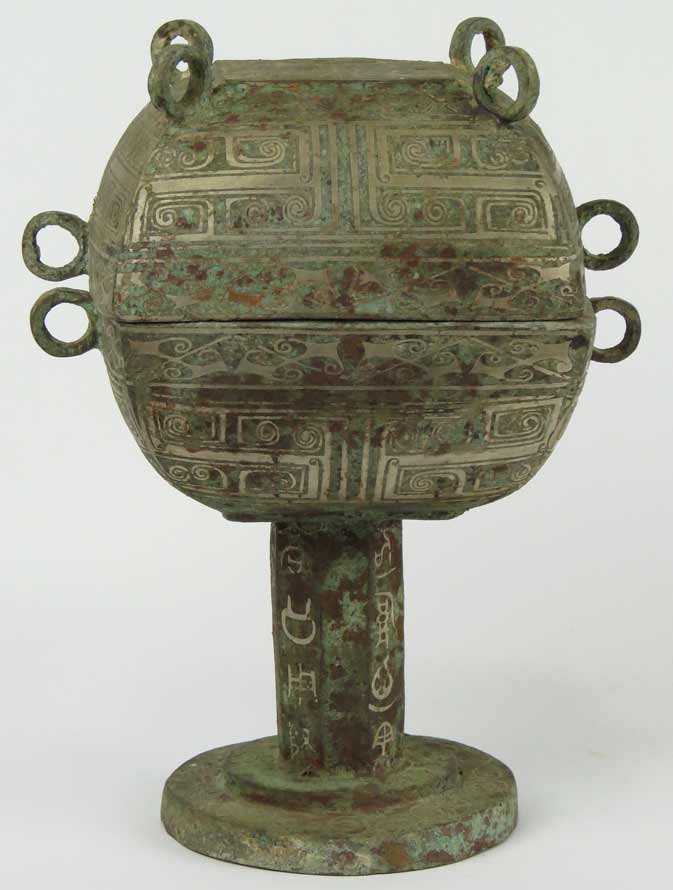 ARCHAIC-STYLE CHINESE INLAID BRONZE DOU: style of the Warring States period (475-221 B.C.) lidded square bowl with curved sides and applied rings, on footed stem inlaid with archaic characters, 10”h; bowl 5.5”w From a Massachusetts North