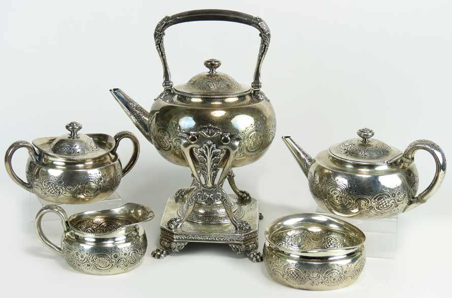 TIFFANY STERLING SILVER TEA SERVICE, #6233: TIFFANY & CO./6233 MAKERS 1413/STERLING SILVER/M five pieces consisting of tipping kettle on stand, a teapot, a covered sugar, a creamer and a waste bowl, repousse band of flowers with chased lace bor