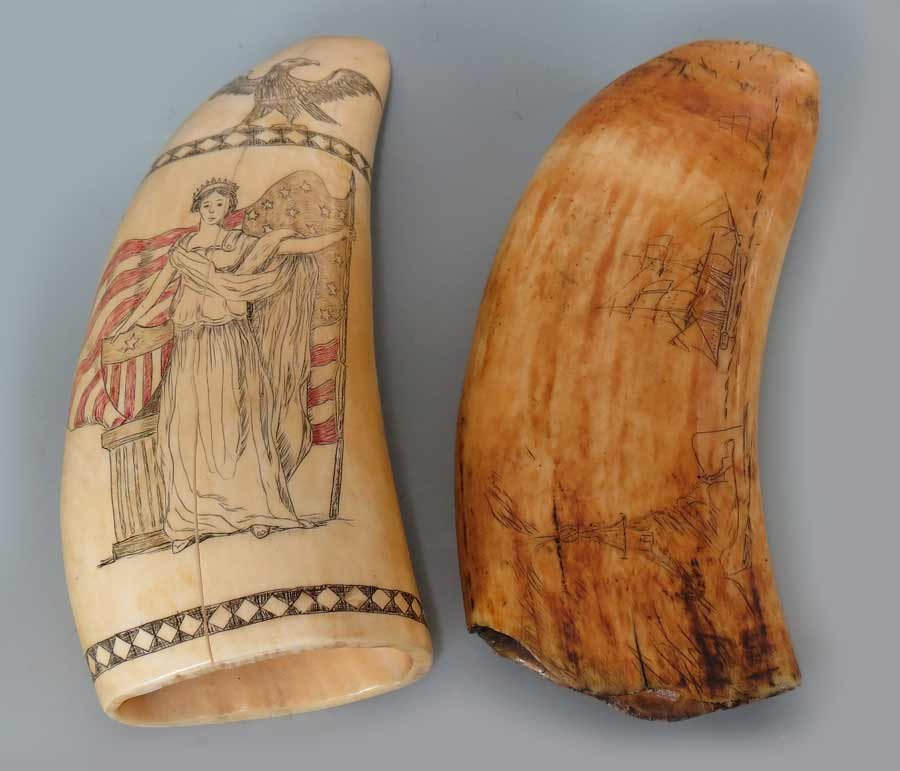 (2) SCRIMSHAW WHALES’ TEETH: America, 19th c., one, the tip with eagle above Lady Liberty standing before a red polychromed highlighted flag and shield; the reverse with fruit in basket and shield with Liberty banner (polished; c