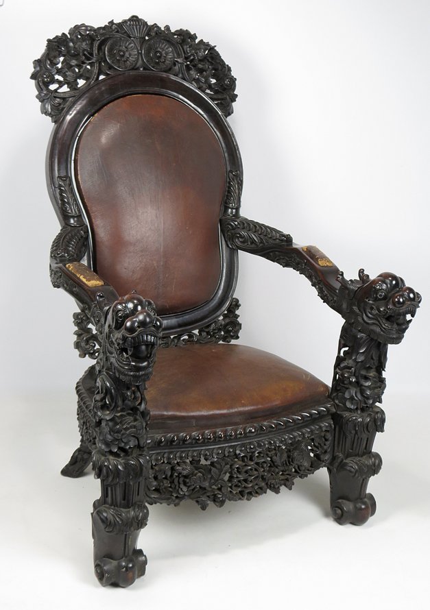 CHINESE HEAVILY CARVED HARDWOOD THRONE CHAIR: 19th c., old color, arms terminating in dragon heads with floating carved balls in mouth, original leather cushions, 53.5”h; 30”w
