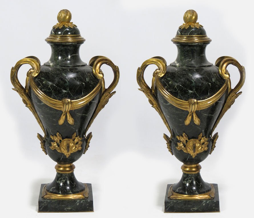 IMPRESSIVE PAIR OF FRENCH ORMOLU AND MARBLE URNS: 19th c., dark green veined marble, the lids with ormolu flower bud, ormolu scrolling leaf and cattail handles, the body draped all around with ribbon swag, ormolu shell and leaf adornment to front, mo