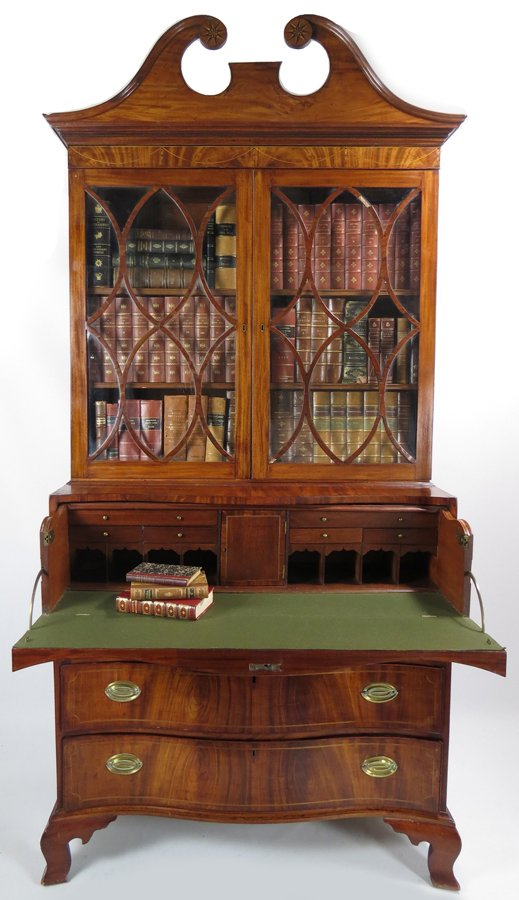 SALEM CHIPPENDALE INLAID MAHOGANY SECRETARY: three-part, old color, pair of glazed doors above four serpentine drawers with old brass, the top drawer fitted with desk, on bold ogee feet, 94”h; 42”w; 21”d