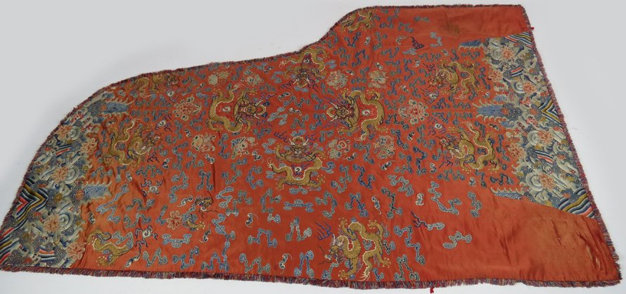 CHINESE DRAGON NEEDLEWORK: custom-pieced together to serve as cover for harpsichord when not being played gold thread dragons, symbols and waves on persimmon silk, fringe added all around, longest length is 86”; at widest 55�