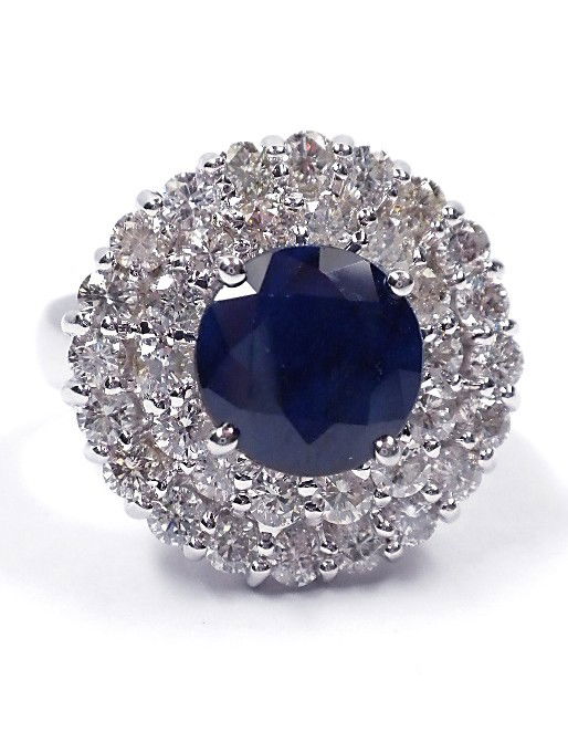 Blue Sapphire and Diamond 14KT White Gold Ring: One Electronically tested 14KT white case sapphire and diamond ring. Condition is new, good workmanship. The featured sapphire is set within a two tired diamond bezel and completed by a two and one ha