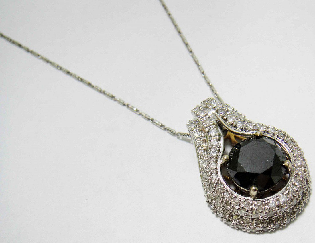 7.77ct Black & White Diamond 14KT Gold Pendant w/ Chain: Total weight of loose Black Diamond: 6.27ct (Clarity: Declasse, Color: Fancy Black) Total weight of Diamonds: 1.50ct (Clarity: SI-2 to I-2, Color: H-I) Total weight of Item: 14.38 Grams