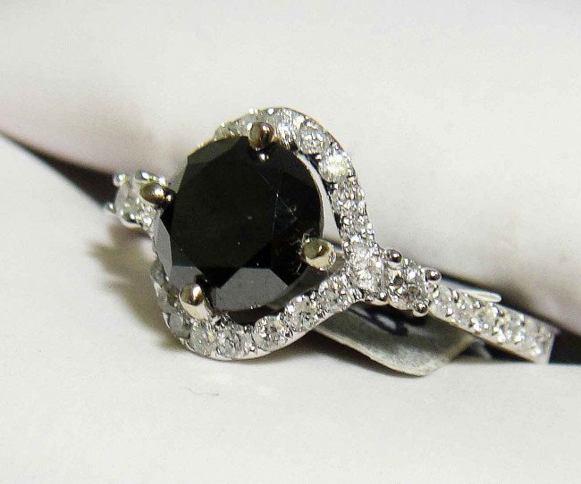 1.73ctw Black & white Diamond 18KT white Gold Rin: Total weight of Black Diamond: 1.39ct (Clarity: Opaque, Color: Black) Total weight of Diamonds: .034ct (Clarity: SI-1/SI-2, Color: H-I) Total weight of Ring: 2.40 Grams
