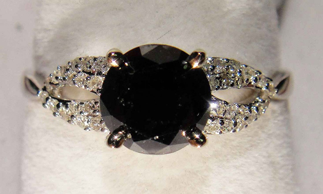 1.72ctw Black & White Diamond 18KT White Gold Ring: Total weight of center Diamond: 1.57ct (Clarity: Opaque, Color: Black) Total weight of Diamonds: 0.15ct (Clarity: SI-1/SI-2, Color: H) Total weight of Ring: 2.30 Grams
