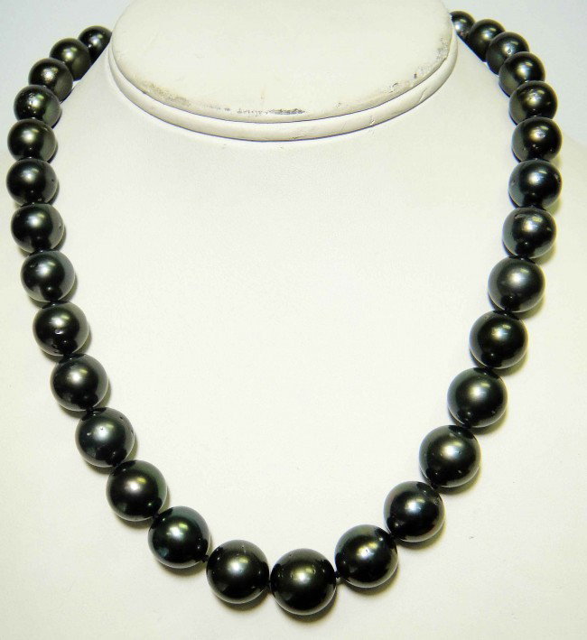 10.5mm -13mm Tahitian Cultured Pearl Necklace: One graduated single strand pearl necklace, eighteen inch princess length, knotted with a silver plunger style clasp containing thirty five Tahitian cultured pearls, 10.50 mm in size to 13.00 mm in si