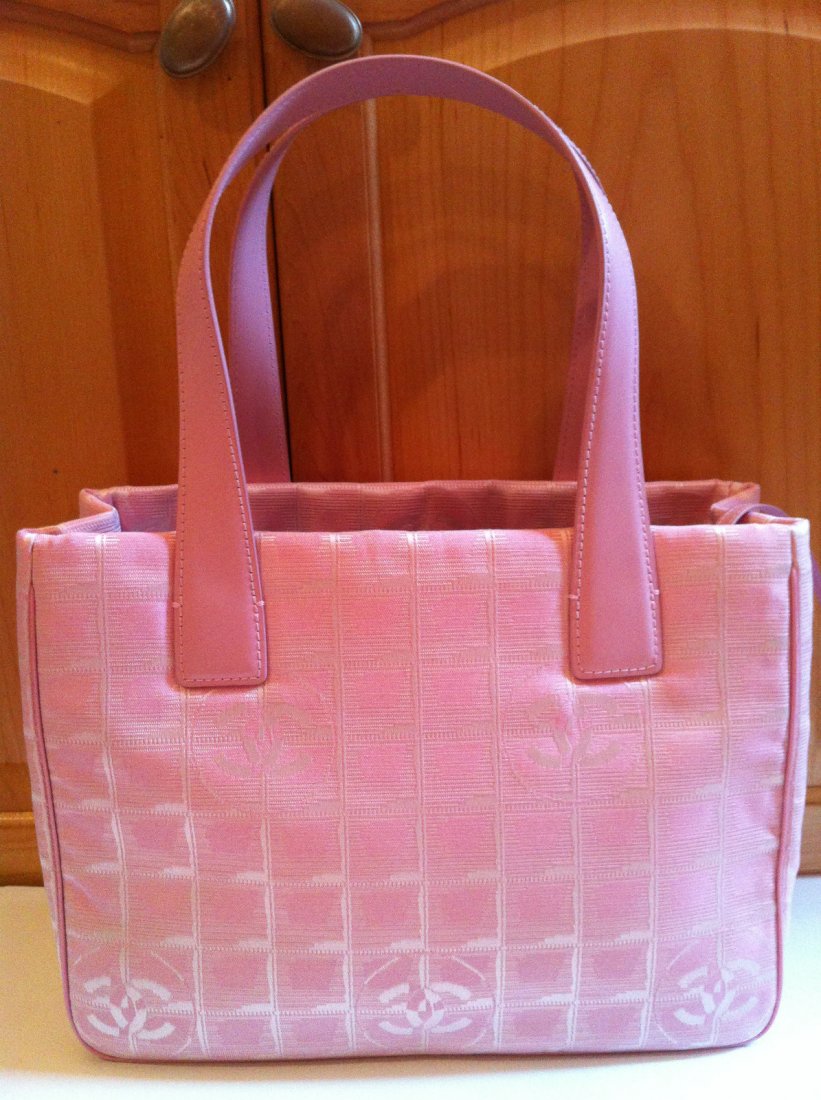 Authentic Chanel Small Pink Fabric Tote Handbag: Authentic Chanel Small Tote is the cutest bag!! Perfect for Spring and summer. Light wait and stunning!! This bag is a "Limited Edition" from Chanel. It is brand new with the tags hanging. It has a la