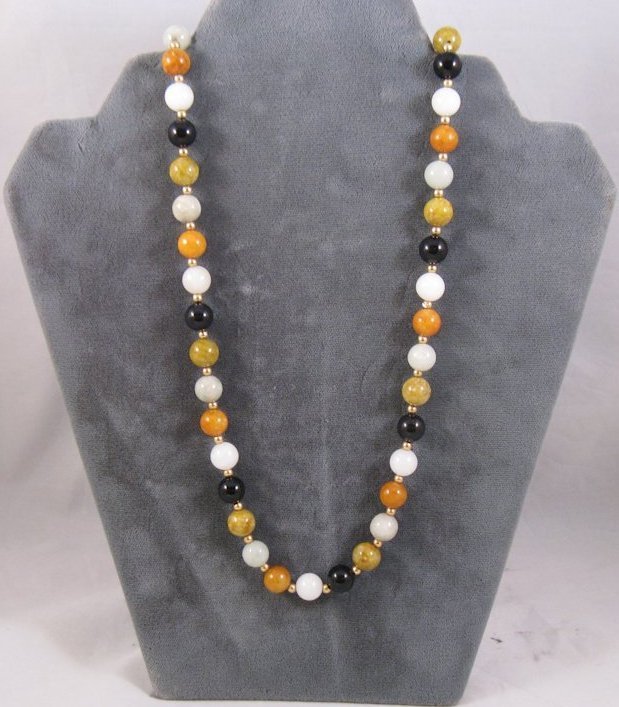 Jade multicolor necklace 14k gold 25 inches: This is a beautiful jade necklace with various color beads and gold balls in between each one. The necklace is 25 inches when stretched out. The fastener is marked 14k and GSJ.