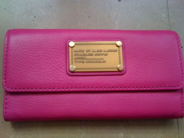 MARC JACOBS FOLD OVER WALLET: MARC BY MARC JACOBS CLASSIC Q TRIFOLD WALLET IN BERRY Snap-flap closure. Interior zip and currency pockets; eight card slots; ID window. Leather. By MARC BY MARC JACOBS; imported.