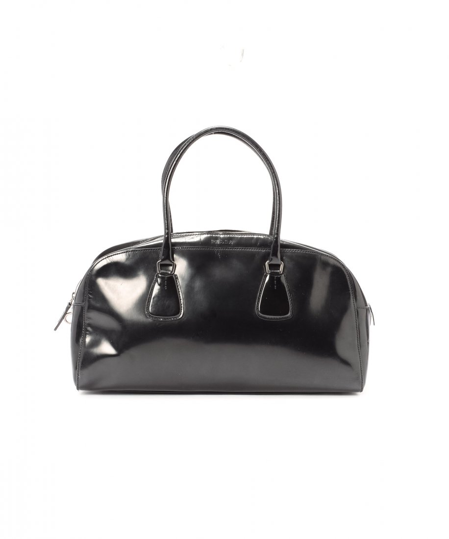 Prada Handbag WX580: Prada Handbag. Black leather body and trims, Black fabric lining, Lightly worn handles, Wrinkles on surface, Faintly stained bottom and surface. There are scratches on the surface, wear on the corners