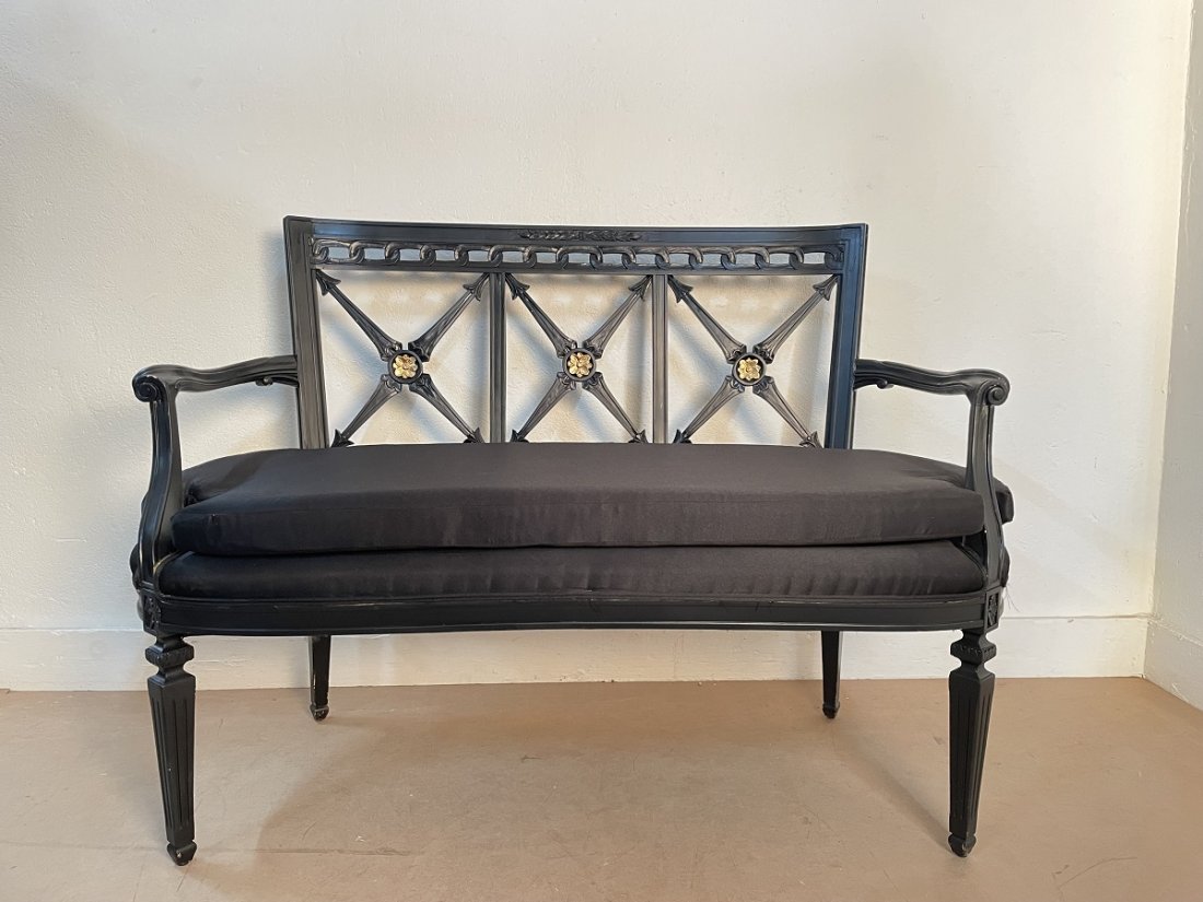 1950s Painted Loveseat: Painted black frame with gold painted floral pattern to the back. Loose cushioned seat. Measures: 35.5H x 50W x 25.5D.