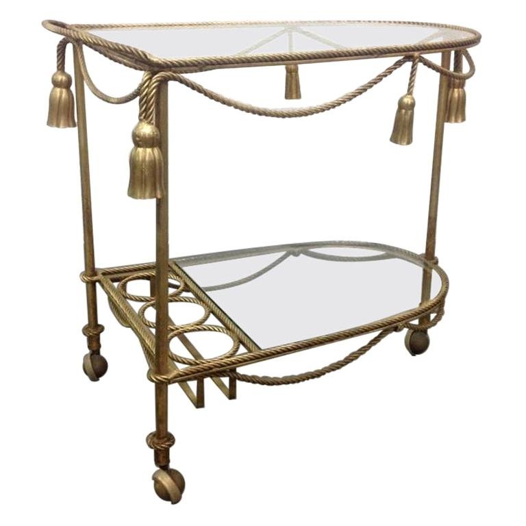 Gold Metal Bar Cart: Gold metal rope and tassel bar cart. Measures: 26H x 18.5W x 29D.