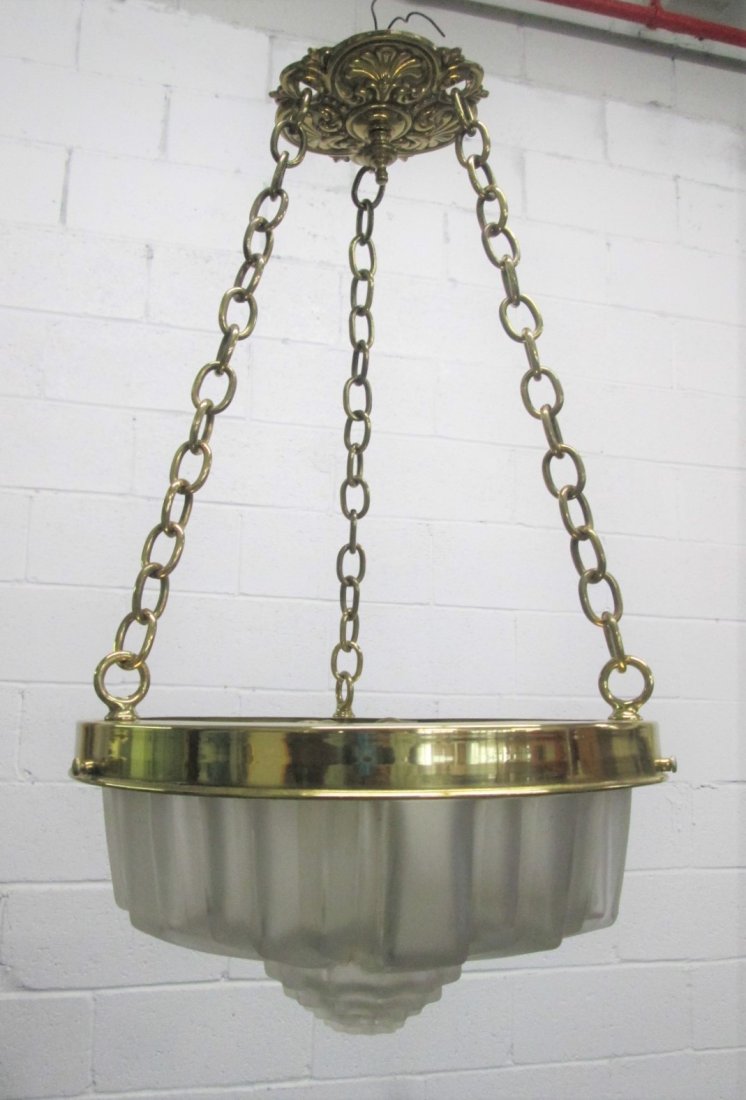 Art Deco Style Glass Chandelier Light Fixture: Art Deco style molded glass hanging light fixture with brass trim, hanging links and cap. Measures: 22H x 12 in diameter.
