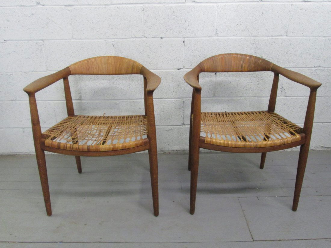 Pair Hans Wegner The Chair for Johannes Hansen. Or: Pair Hans Wegner The Chair for Johannes Hansen. Original cane to the seats. Solid teak frames. Both chairs have rips and loose caning to the seats. Measures: 25"W x 20"D x 30"H