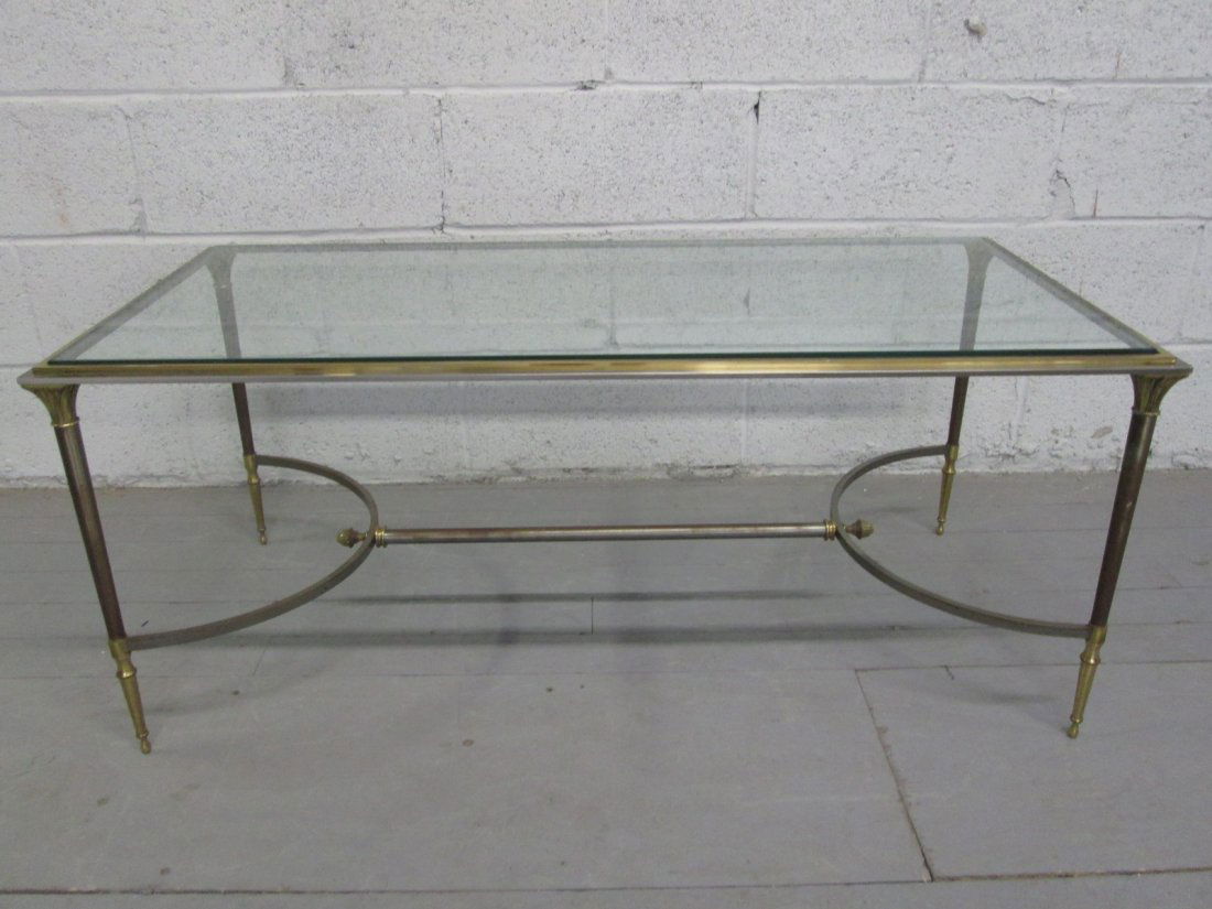 Maison Jansen Style Coffee Table: Polished chrome and brass frame with glass top. Minor scratches to the glass. Measures: 20"D x 42"W x 17.5"H