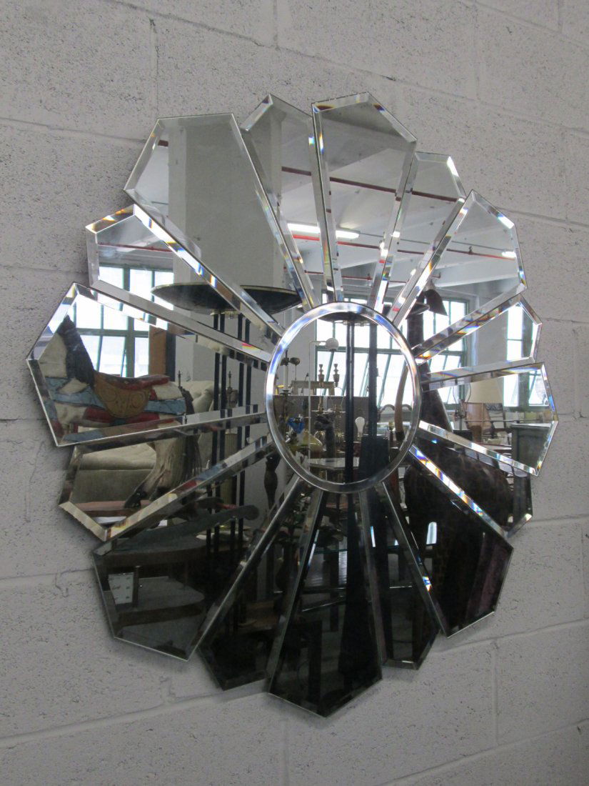Beveled Sunburst Mirror: Sunburst style wall mirror with beveled edges. Measures: 40.25" diameter.