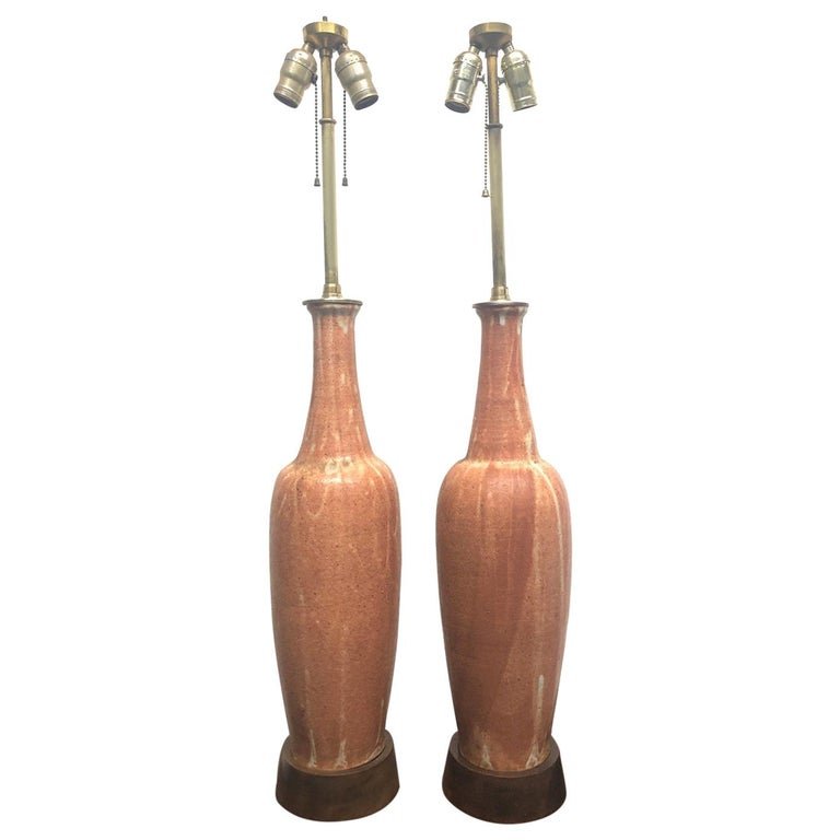 Italian Ceramic Lamps Raymor Pair: Pair of ceramic Italian lamps for Raymor. The base of the lamps is walnut. Measures: 39 height (to top of finial). Under socket: 23.25 height. Body: 5.25 diameter. Base: 5.75 diameter.