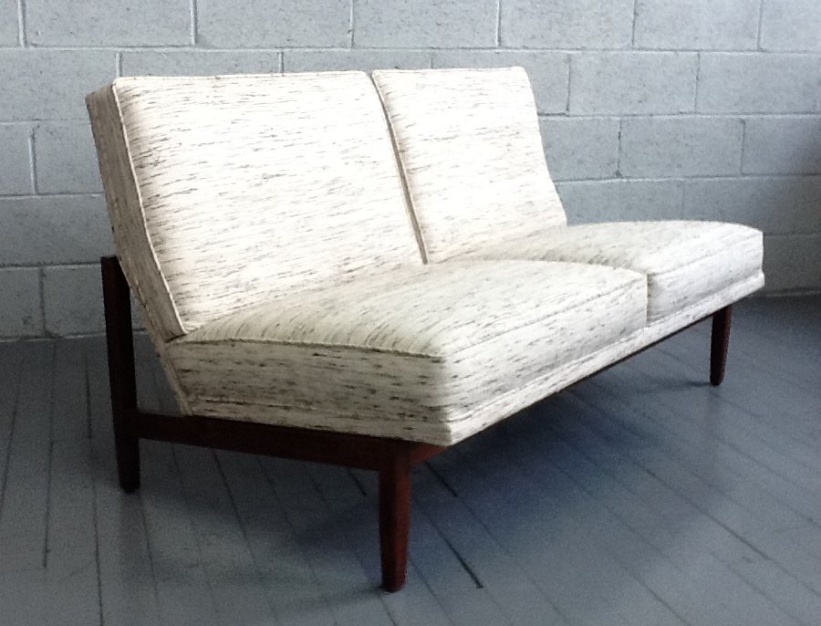 Knoll Loveseat: Newly upholstered with walnut frame. Minor scratches to the frame. Measures: 31"H x 56"W x 30.5"D