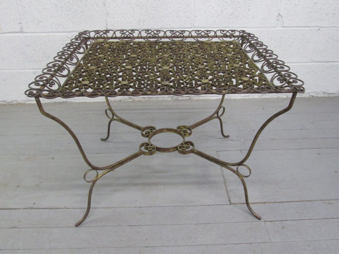 Antique Style Wrought Iron Table: Table has a removable tray top with brass round decorative accents. In good condition. Measures: 20"H x 24"D x 28"W
