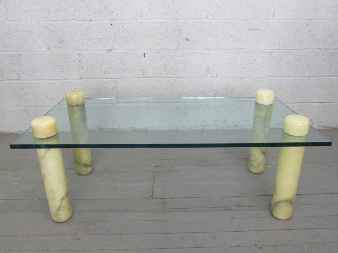 Stone & Glass Top Coffee Table: 4 cylindrical stone legs with glass top table. Measures: 48"W x 24"D x 20"H