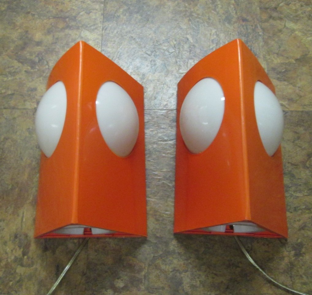 Pair Joe Colombo Sconces: Pair of orange and white sconces by Joe Colombo. Made of a hard plastic material. Measures: 10"H x 6.5"W.