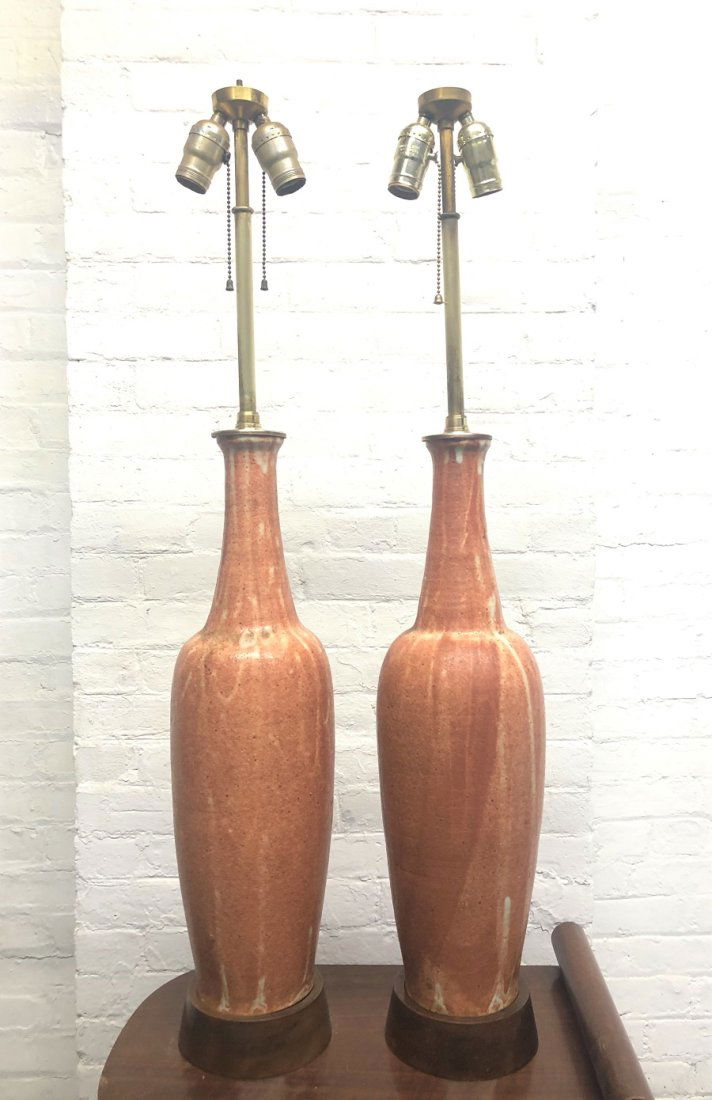 Italian Ceramic Lamps Raymor Pair: Pair of ceramic Italian lamps for Raymor. The base of the lamps is walnut. Measures: 39 height (to top of finial). Under socket: 23.25 height. Body: 5.25 diameter. Base: 5.75 diameter.