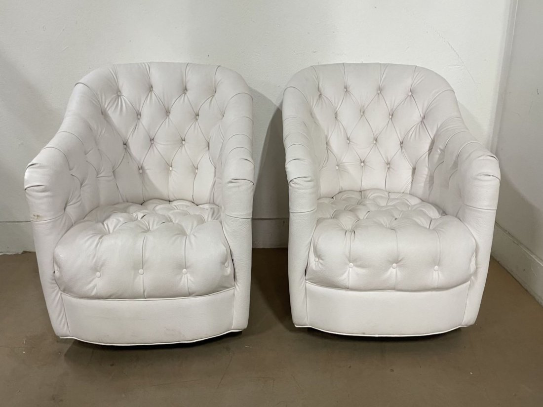Ward Bennett Style Tufted Chairs - Pair: Ward Bennett Style Tufted Chairs in white vinyl with casters. Measures: 28.5H x 29W x 24D.