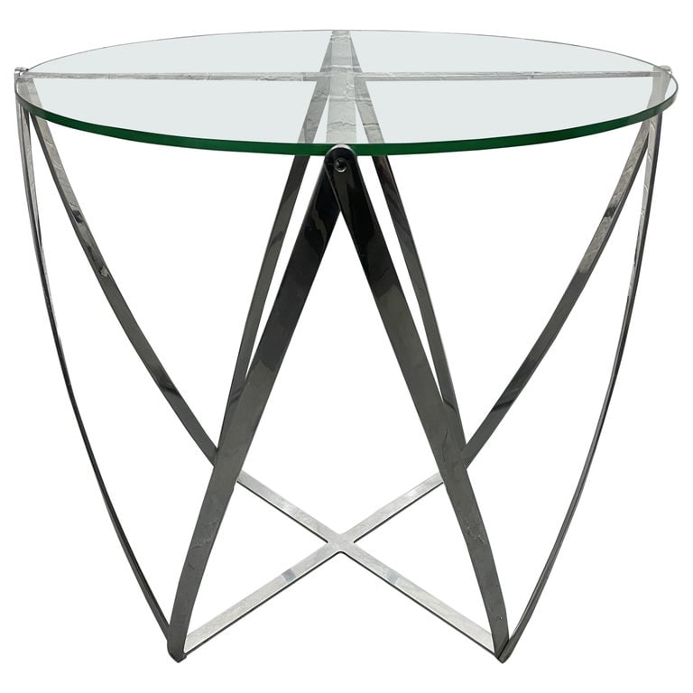 John Vesey Side Table: Polished aluminum frame with glass top side table. Measures: 28H x 29 in diameter.