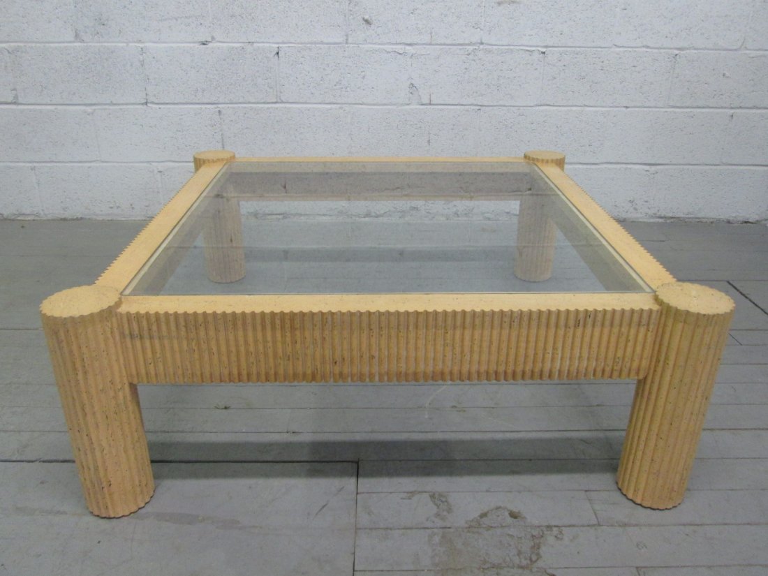 Mid Century Modern Glass Top Coffee Table: Sculpted coffee table with glass top. Has cylindrical style legs. 41.25"W x 41.25"D x 15"H