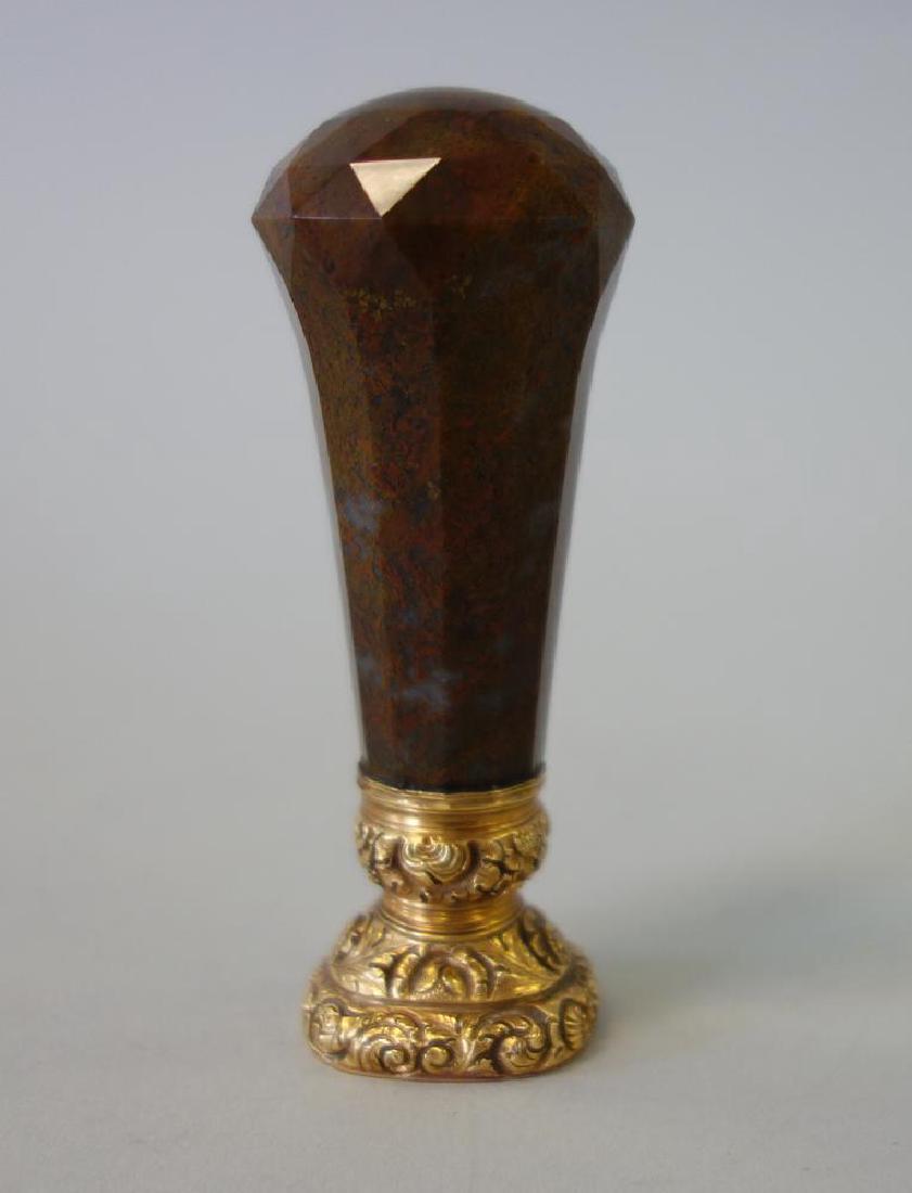 Handled Fob Seal, Armorial Intaglio & Motto: A faceted bloodstone handled gold fob seal with crystal armorial intaglio crest. The motto beneath the crest reads: Utile et Dulce (Useful and Agreeable) and was used by the Riddell family. Measures 3
