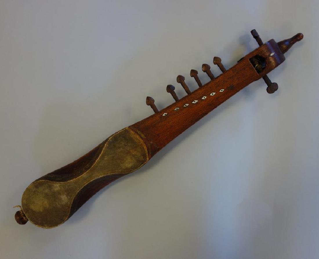Antique Afgahani Inlaid Rubab Musical Instrument: An antique carved wood Rubab. Lute like musical instrument originating in Afghanistan. Carved bird formed finial, bone inlay. Measures 21.5" long, 3" wide, 2.25" high. CONDITION NOTE: missing one tuni