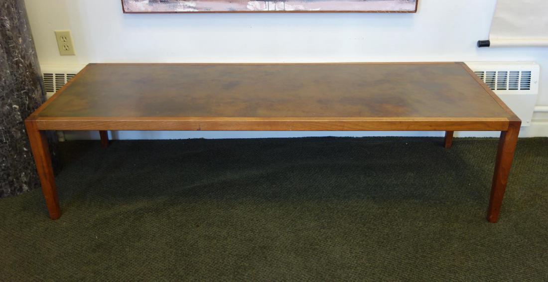 Harry Lunstead Copper & Walnut Coffee Table: A Harry Lunstead rectangular coffee table. Walnut table inset with the trademark acid-treated copper top. Measures 62.75" long, 21.75" deep, 16" high. The underside retains the original Harry Lunstead